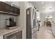 Modern kitchen featuring stainless steel appliances, a wine cooler, and ample counter space for cooking and entertaining at 13409 Ramblewood Trl, Bradenton, FL 34211