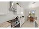 Updated kitchen featuring stainless steel appliances, granite countertops, white cabinets and eat-in kitchen dining area at 13409 Ramblewood Trl, Bradenton, FL 34211