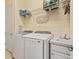 Functional laundry room with a front load washer and dryer, sink, and shelving for storage at 13409 Ramblewood Trl, Bradenton, FL 34211