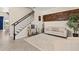 Bright living room features a staircase, elegant décor, a stylish rug, and comfortable seating for a welcoming ambiance at 13409 Ramblewood Trl, Bradenton, FL 34211