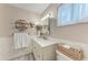 Well-lit bathroom with a vanity, unique storage shelves, and stylish decor at 1520 Lakeside Way # 147, Sarasota, FL 34232