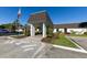 Community entrance with landscaped greenery and an American flag at 1520 Lakeside Way # 147, Sarasota, FL 34232