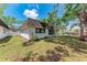 Bright exterior with large windows overlooking a grassy lawn and mature trees at 1520 Lakeside Way # 147, Sarasota, FL 34232