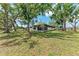 Inviting home exterior surrounded by mature trees and lush landscaping, perfect for nature lovers at 1520 Lakeside Way # 147, Sarasota, FL 34232