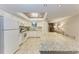 Well-lit kitchen with a large island, tile flooring, and views to the hallway at 1520 Lakeside Way # 147, Sarasota, FL 34232