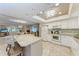 Open-concept kitchen featuring white appliances, an island, and a seamless view into the dining and living areas at 1520 Lakeside Way # 147, Sarasota, FL 34232