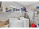 Functional laundry room with modern washer, dryer, shelves and window for natural light at 1520 Lakeside Way # 147, Sarasota, FL 34232