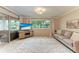 Inviting living room with large windows, neutral furniture, and decorative rug at 1520 Lakeside Way # 147, Sarasota, FL 34232