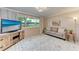 Inviting living room with large windows, neutral furniture, and decorative rug at 1520 Lakeside Way # 147, Sarasota, FL 34232