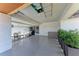 View of the home's covered parking area with outdoor seating, barbecue, and ample storage space at 1520 Lakeside Way # 147, Sarasota, FL 34232