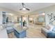 Relaxing enclosed patio with wicker furniture and a ceiling fan; access to indoor living space through sliding glass doors at 1520 Lakeside Way # 147, Sarasota, FL 34232