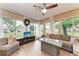 Bright sunroom surrounded by windows with comfortable seating at 1520 Lakeside Way # 147, Sarasota, FL 34232