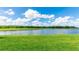 Expansive backyard view features lush green grass and a serene lake at 15722 San Lazzaro Ave, Lakewood Ranch, FL 34211