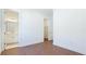 Bright bedroom featuring hardwood floors and an open doorway to a bathroom with double vanity at 15722 San Lazzaro Ave, Lakewood Ranch, FL 34211