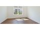 Bright bedroom with hardwood floors and a window providing natural light and views of the neighborhood at 15722 San Lazzaro Ave, Lakewood Ranch, FL 34211