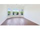 Bright bedroom with hardwood floors, neutral walls, a tray ceiling, and scenic views of the outdoors at 15722 San Lazzaro Ave, Lakewood Ranch, FL 34211