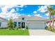Beautifully landscaped single Gathering home featuring a well manicured lawn and a charming two car garage at 15722 San Lazzaro Ave, Lakewood Ranch, FL 34211