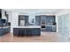 Contemporary kitchen with a large island, stainless steel appliances, and a sleek tile backsplash at 15722 San Lazzaro Ave, Lakewood Ranch, FL 34211