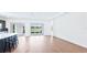 Expansive living area showcasing hardwood floors, natural light, and an adjacent kitchen and outdoor access at 15722 San Lazzaro Ave, Lakewood Ranch, FL 34211