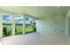 Covered patio featuring bright lighting and stunning views of the nearby pond and lush green landscape at 15722 San Lazzaro Ave, Lakewood Ranch, FL 34211