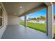 Covered back porch area provides a relaxing outdoor space with views of the backyard at 16206 Arcaro Ave, Port Charlotte, FL 33954
