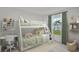 bedroom features a bunk bed, study desk, and a window with natural light at 16206 Arcaro Ave, Port Charlotte, FL 33954