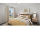 Comfortable bedroom features a large window and stylish decor with a neutral palette at 16206 Arcaro Ave, Port Charlotte, FL 33954