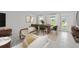 Open-concept dining and living area filled with natural light and stylish furnishings at 16206 Arcaro Ave, Port Charlotte, FL 33954