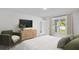 Cozy bedroom with large window, comfortable seating, and stylish decor for relaxation at 16206 Arcaro Ave, Port Charlotte, FL 33954