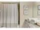 Bathroom featuring a shower with curtain, modern fixtures and granite countertop at 1622 Stafford Ln # 1205, Sarasota, FL 34232