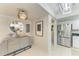 Hallway with stylish decor and a view into the modern kitchen at 1622 Stafford Ln # 1205, Sarasota, FL 34232