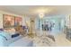 Open-concept living room featuring dining space, stylish decor, comfortable seating, and abundant natural light at 1622 Stafford Ln # 1205, Sarasota, FL 34232