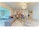 Bright living room featuring a gray sectional sofa, decorative rug, and modern chandelier at 1622 Stafford Ln # 1205, Sarasota, FL 34232