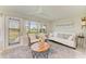 Bright sunroom featuring a door to the outside, comfortable seating, and peaceful views of the outdoors at 1622 Stafford Ln # 1205, Sarasota, FL 34232