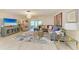 Spacious living room with dining area, bright lighting, and comfortable seating in an open-concept design at 1622 Stafford Ln # 1205, Sarasota, FL 34232