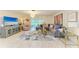 Open-concept living room with an elegant chandelier, large TV, comfortable seating, and stylish decor at 1622 Stafford Ln # 1205, Sarasota, FL 34232