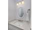 Cozy bathroom features modern fixtures, granite countertops, and an oval mirror at 212 Milan W Ave # 1, Venice, FL 34285