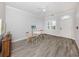 Living room with a dining table set, white ceilings, crown molding and wood floors at 212 Milan W Ave # 1, Venice, FL 34285