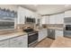 Modern kitchen with stainless steel appliances, granite countertops, and white cabinetry at 2151 Upton Ave, Sarasota, FL 34232