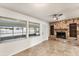 Cozy living room with a stone fireplace and windows, offering natural light at 2151 Upton Ave, Sarasota, FL 34232