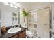 Bathroom featuring a vanity with a dark granite countertop and a glass-enclosed shower at 2177 Weaver Bird Ln, Venice, FL 34292