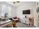Bright bedroom with a ceiling fan, natural light, and a comfortable area for working or relaxing at 2177 Weaver Bird Ln, Venice, FL 34292