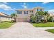 Charming two-story home featuring a paved driveway, manicured lawn and mature landscaping at 2177 Weaver Bird Ln, Venice, FL 34292