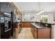 Spacious kitchen boasting dark wood cabinets, granite countertops, and stainless steel appliances at 2177 Weaver Bird Ln, Venice, FL 34292