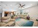 Living room area featuring tile flooring, large sectional sofa, and a view to the kitchen at 2177 Weaver Bird Ln, Venice, FL 34292