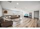 Expansive living room featuring wood-look floors, a ceiling fan, and comfortable seating area at 2177 Weaver Bird Ln, Venice, FL 34292