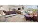 A large, bright primary bedroom with big windows and a comfortable sitting area at 2177 Weaver Bird Ln, Venice, FL 34292