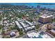 An aerial view of a modern townhome community nestled in a vibrant urban setting with a cityscape in the background at 221 Cosmopolitan Ct, Sarasota, FL 34236