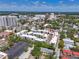 Aerial view of modern townhome community in a cityscape, surrounded by lush greenery and city amenities at 221 Cosmopolitan Ct, Sarasota, FL 34236