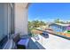 Enjoy the outdoor breeze and views from this balcony with stylish seating, perfect for relaxing at 221 Cosmopolitan Ct, Sarasota, FL 34236